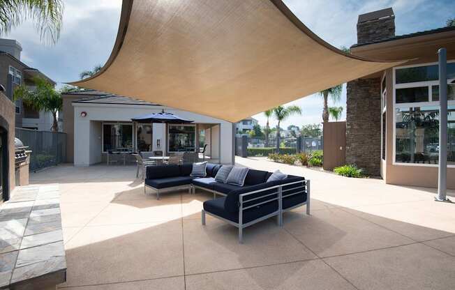 A modern outdoor seating area with a curved wooden roof.