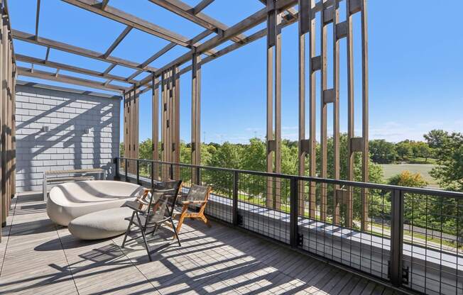 Wooden deck with a metal railing and a chair at Park77 Apartments, Cambridge, Massachusetts