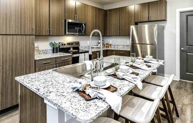 A kitchen with a granite countertop and a sink.