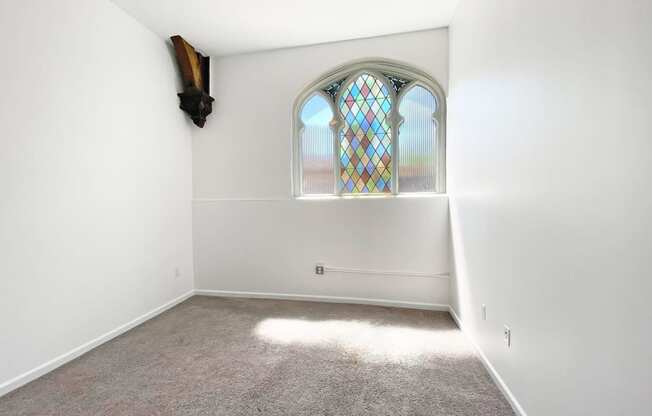 Carpeted Bedroom with Unique Window at University Commons, Pittsburgh 15213