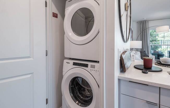 a white washer and dryer in a white laundry room at Altis Grand Lake Willis, Orlando Florida