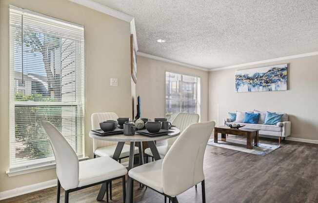 a dining room with a table and chairs and a window at The Glen at Highpoint, Dallas, 75243