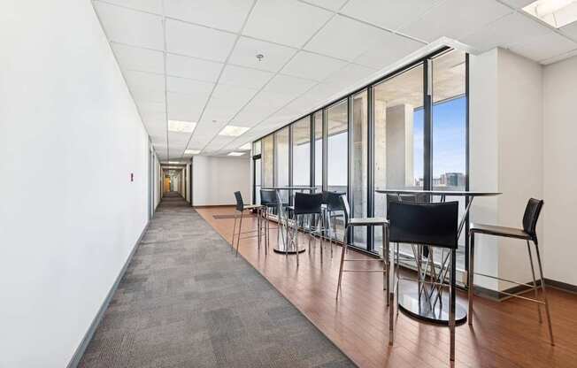 A long hallway with chairs and a carpeted floor.