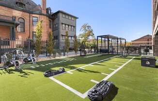 a soccer field in front of a building with bags on it