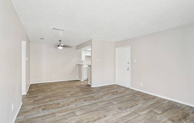 A5 living room with vinyl wooden flooring at Windridge on the Parkway apartments in Dallas, TX