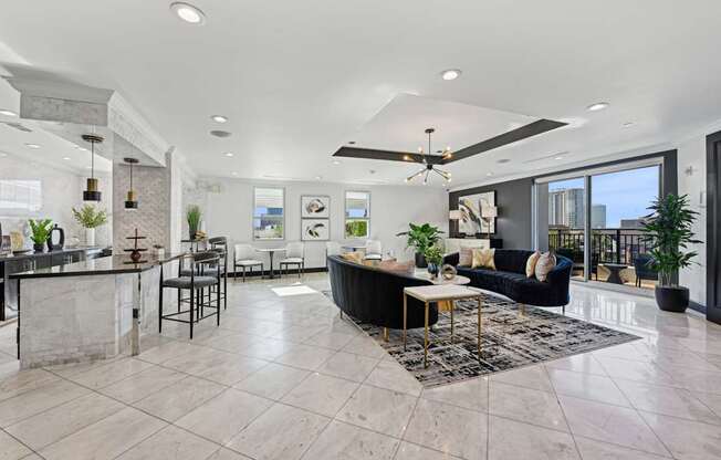 Spacious resident lounge with a kitchen area in the background at Dominion Post Oak apartments in Houston, TX