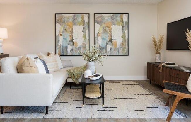 a living room with a white couch and a table
