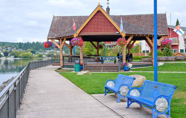 a park with benches and a gazebo near the water at Woodcreek, Poulsbo, 98370