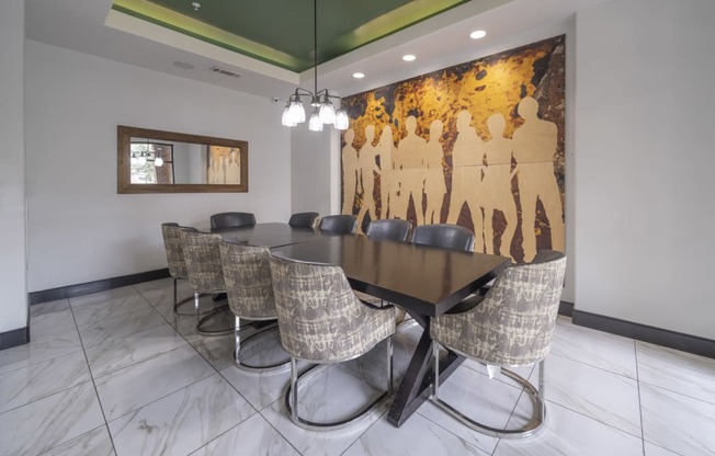 a conference room with a long table and chairs and a mural on the wall at The Hendrix, Atlanta, GA