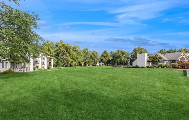 a large green lawn in front of houses