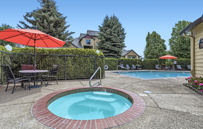 a swimming pool and patio with chairs and an umbrella