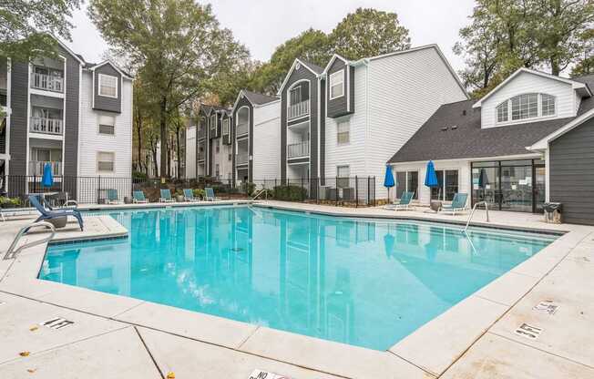 A swimming pool surrounded by apartment buildings.