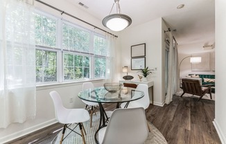 a dining room with a glass table and chairs