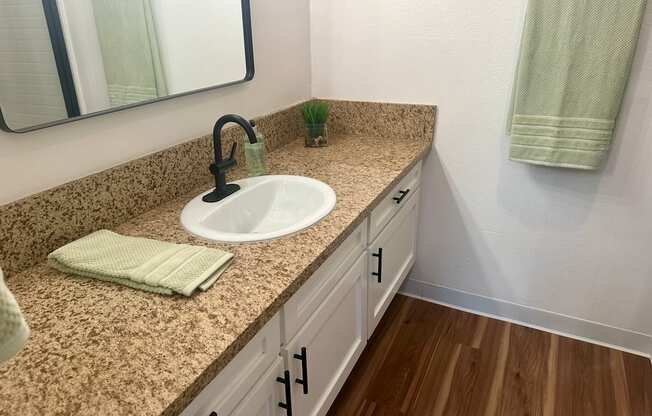 A bathroom with a sink and a mirror at Willow Tree Apartments, California, 90505