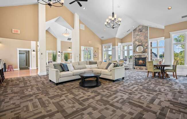 A spacious living room with a patterned carpet and a fireplace.