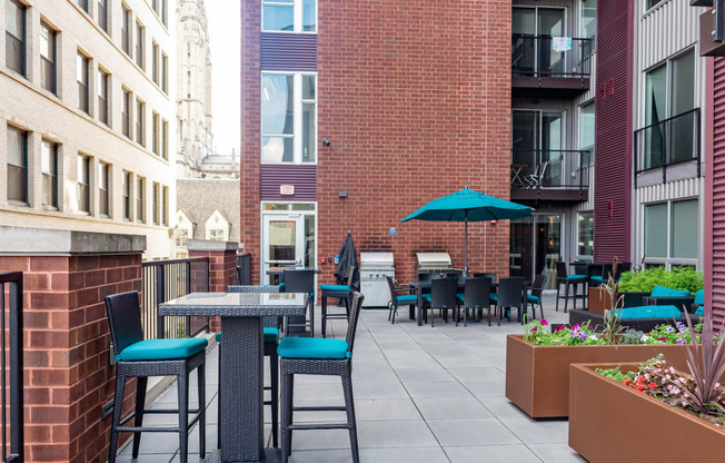 an outdoor patio with tables and chairs at the bradley braddock road station apartments