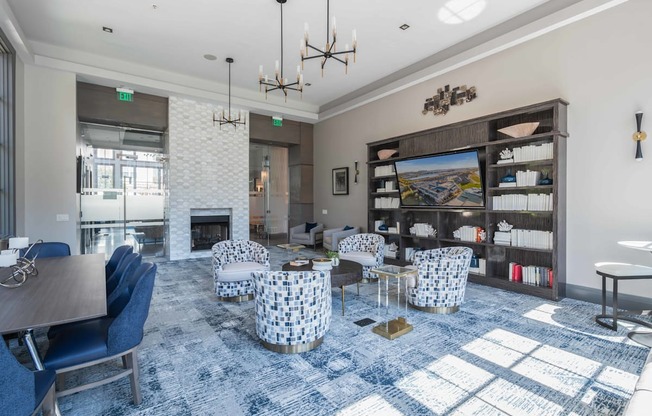 A large room with a fireplace and a blue carpet.