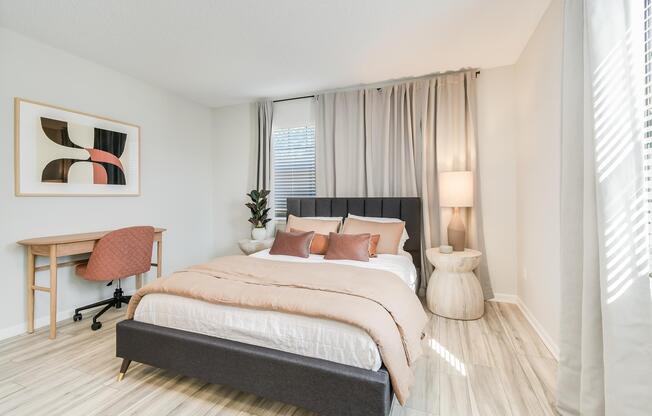 Bed and desk inside platinum bedroom interior at The Arbor in Blue Springs, Missouri