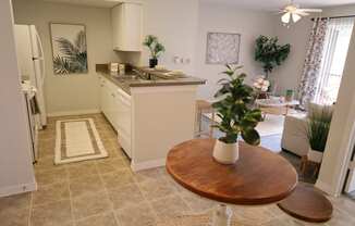 a kitchen and living room with a dining room table and a sink