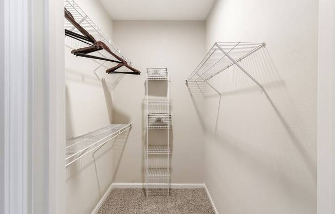 a spacious walk in closet with white walls at Cumberland Place Apartment Homes, Tyler, Texas