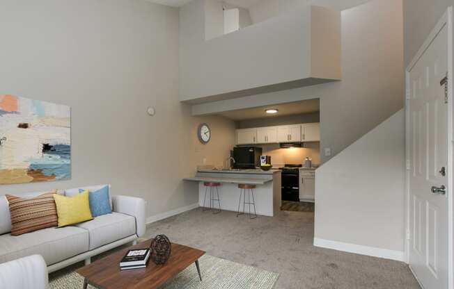 a living room and kitchen with a couch and a coffee table