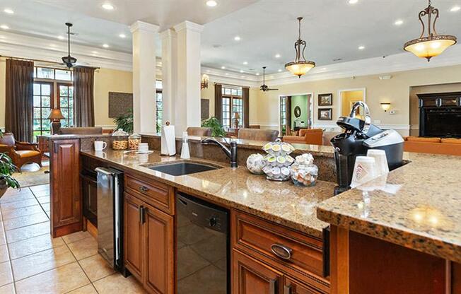 a large kitchen with a sink and a counter top at Bedford Parke Apartments, Warner Robins, GA