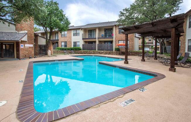 a house with a pool in front of a building