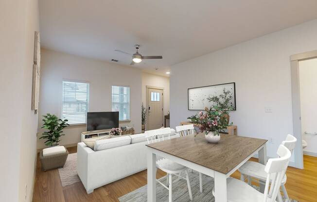 a living room and dining room with white furniture and a table