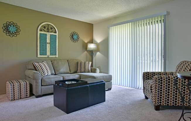 a living room with a couch chairs and a coffee table at Beacon Hill and Great Oaks Apartments, Rockford, Illinois