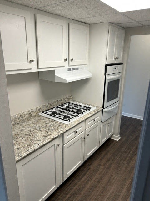 White kitchen cabinets with luxury vinyl planking