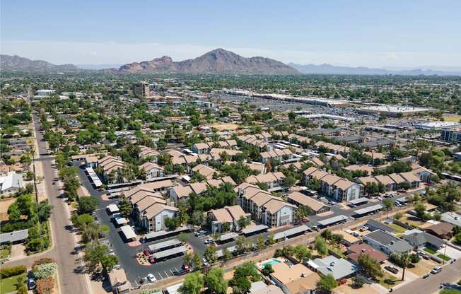 an aerial view of a city with a mountain in the background