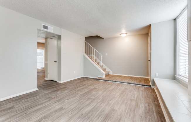 the spacious living room and dining room of an apartment