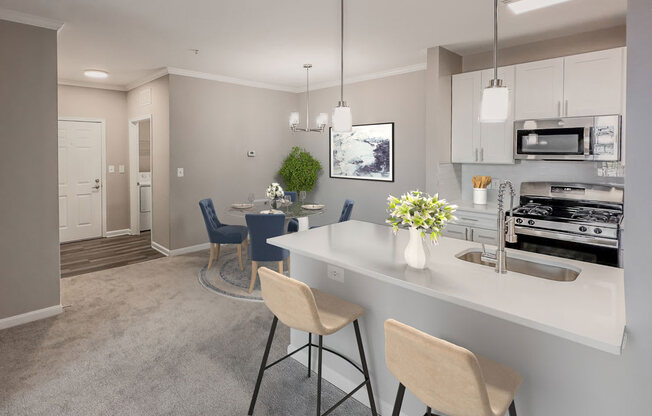 an open kitchen and dining area with a white counter top