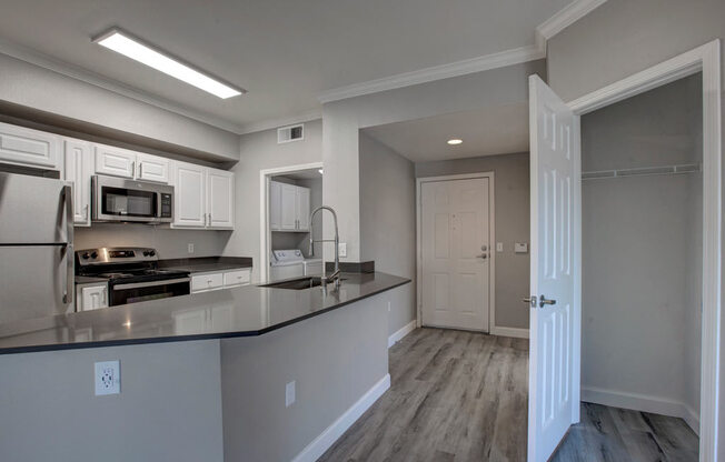 a kitchen with a counter top and a stove top oven