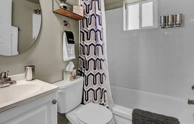 a bathroom with a toilet and a tub and a sink