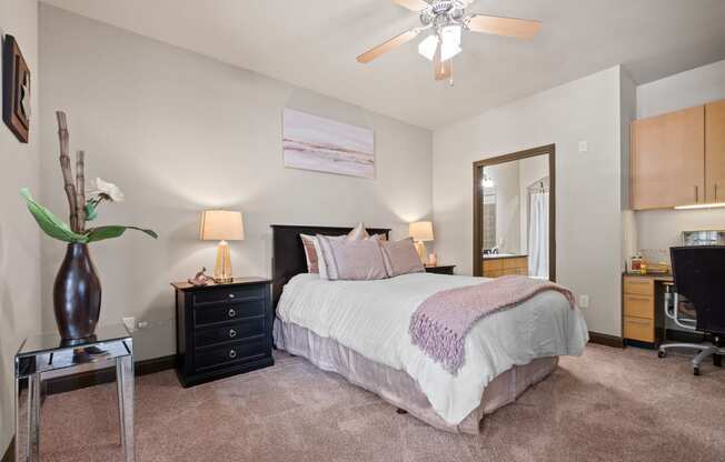 a bedroom with a bed and a ceiling fan