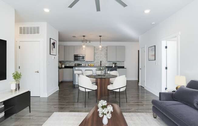 a living room and kitchen with a table and chairs