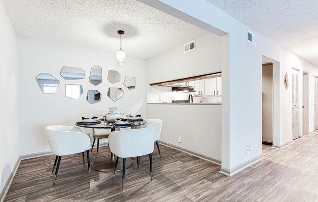 A dining room with a table set for four.