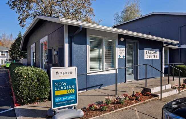 A blue building with a sign that says "aspire leasing center".