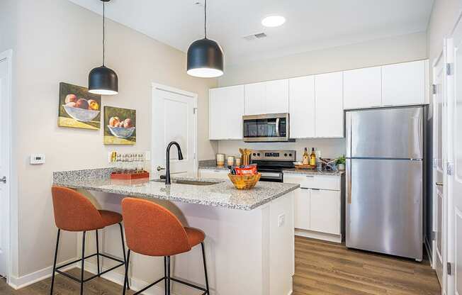 A kitchen with a granite countertop and a refrigerator.