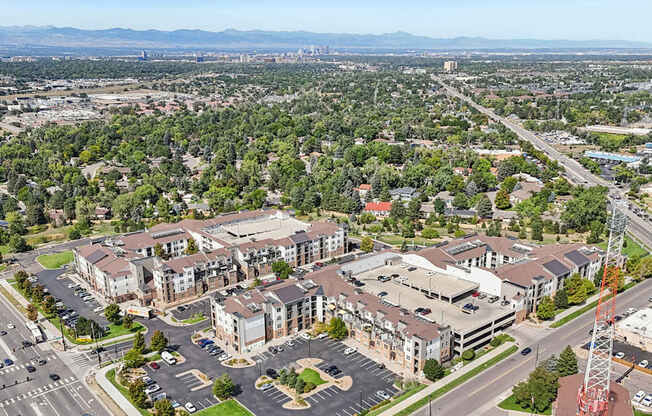 A large building complex with a parking lot in front of it.