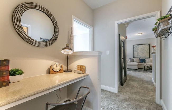 a home office with a desk and a mirror