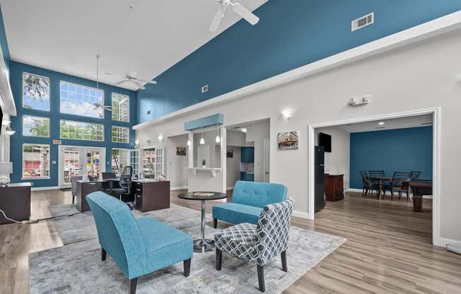 A living room with a blue chair and a patterned chair.