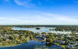 an aerial view of a body of water with houses and trees