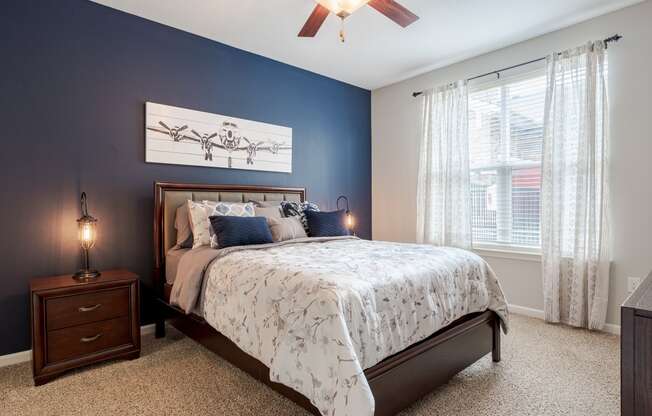 a bedroom with a bed and a ceiling fan