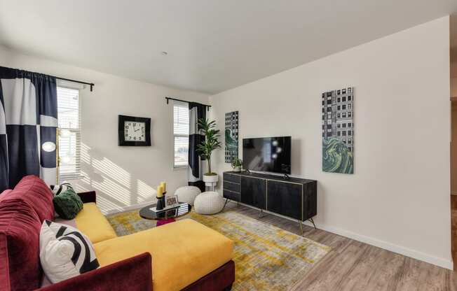 living room with red and yellow couch and Harwood inspired flooring at Morgan Ranch Apartments, California, 95037
