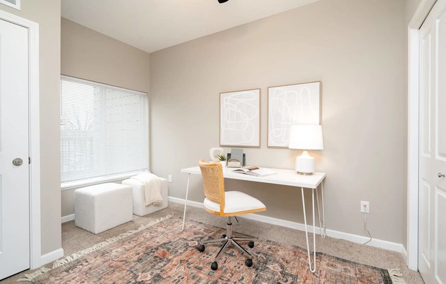 a home office with a desk and a window. Circle Pines, MN Lexington Lofts