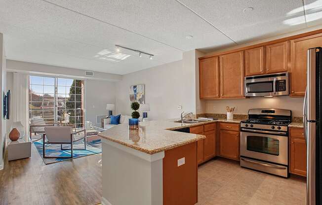 A kitchen with a refrigerator, oven, and microwave.