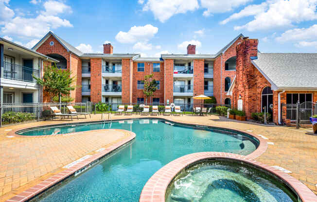 a swimming pool with an apartment building in the background