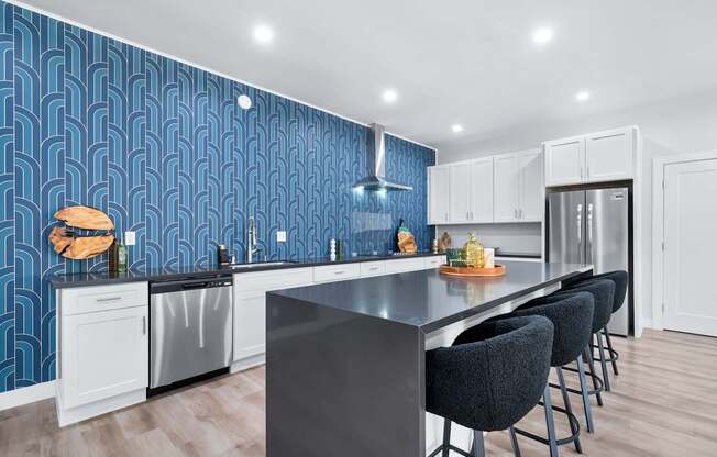 A kitchen with a black countertop and white cabinets.